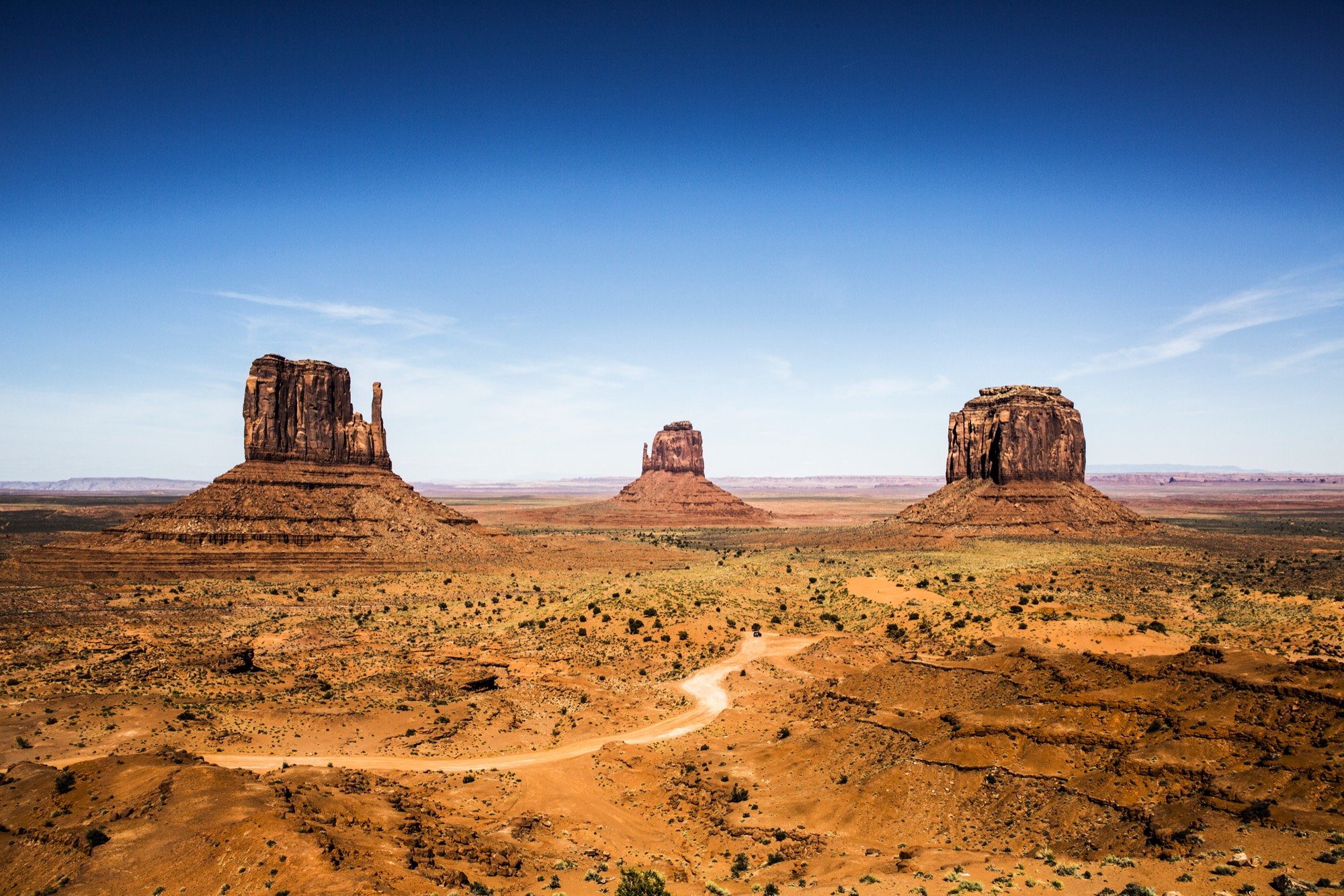 The sandstone buttes of Monument Valley under blue sky