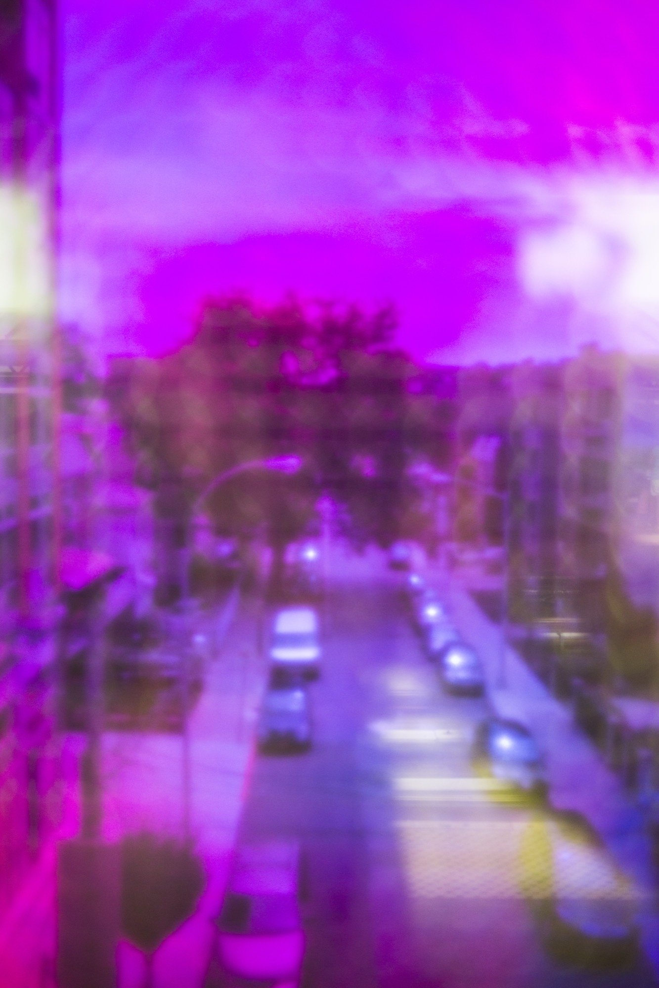 A dreamlike violet blur of a city street