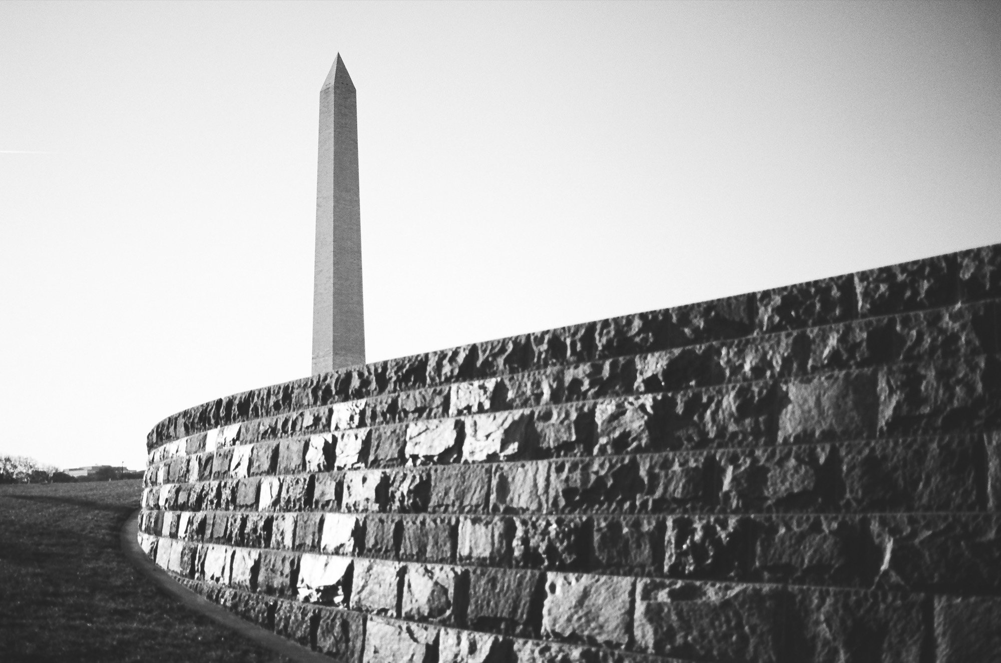 The Washington Monument beyond a curving stone wall