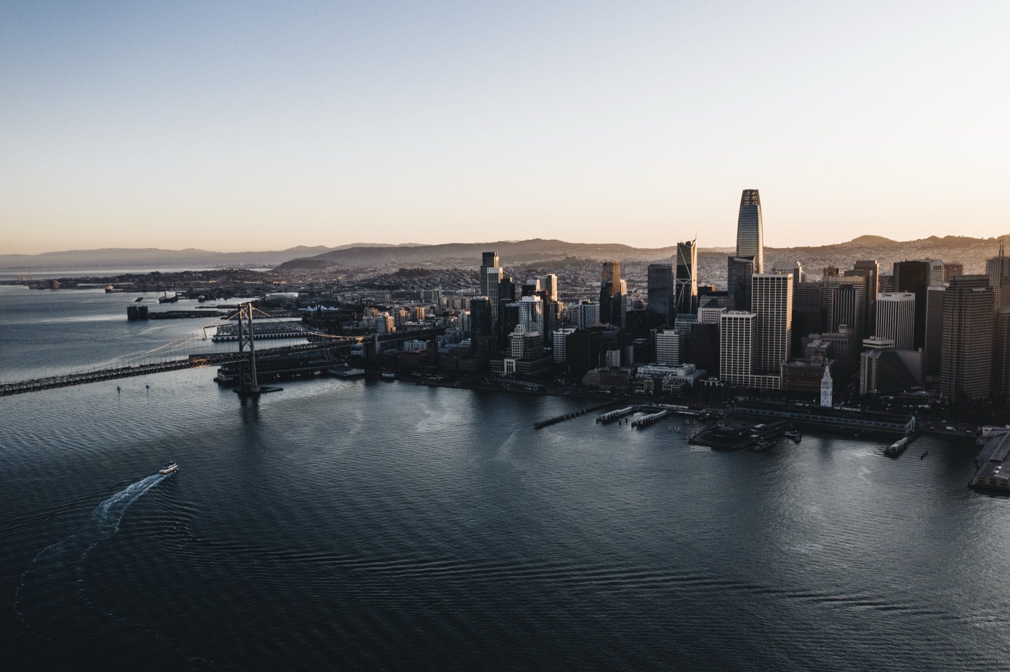 A waterfront city skyline at dusk