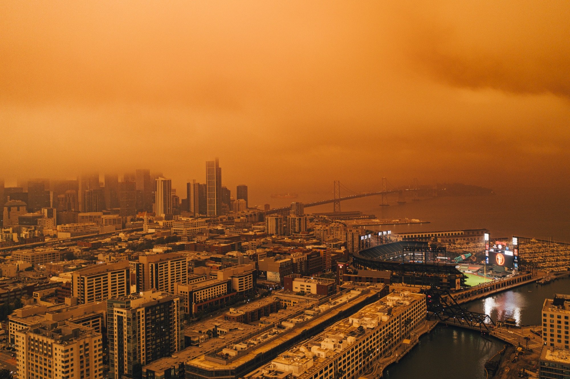 A smoke-shrouded city skyline from above
