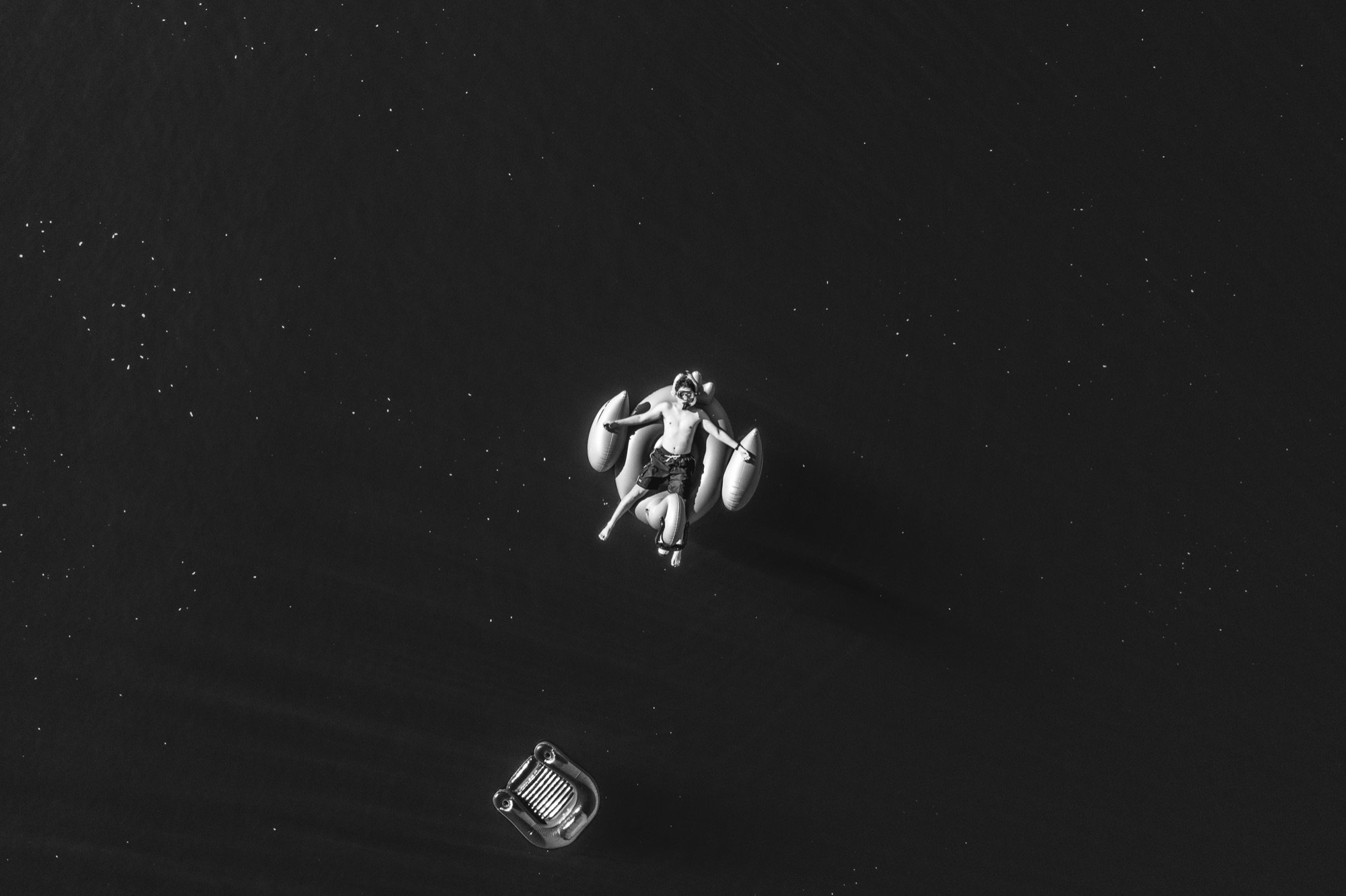 A lone swimmer on dark open water