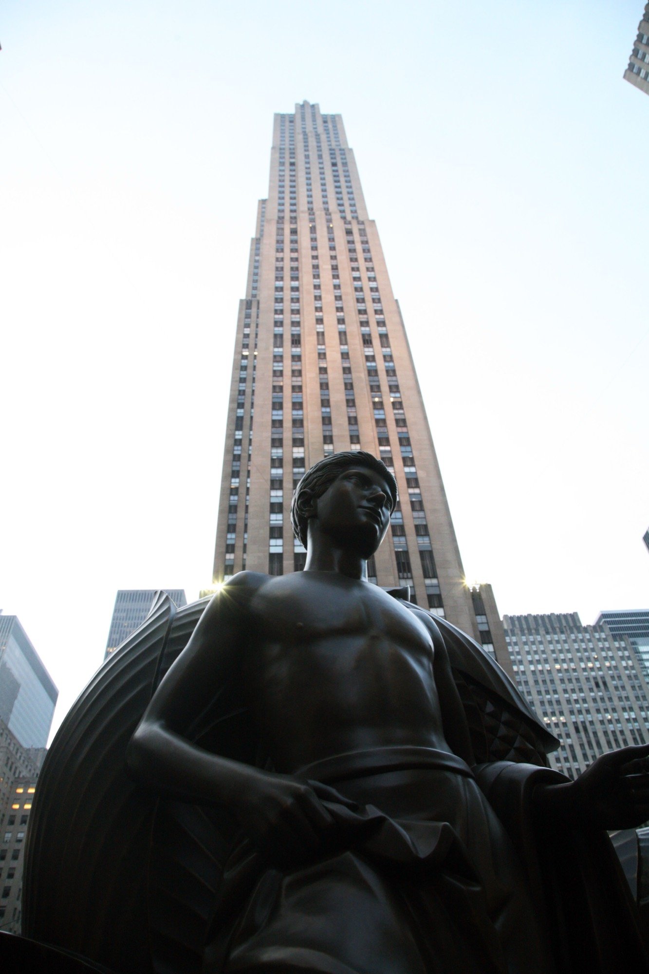 A bronze statue beneath a skyscraper at Rockefeller Center