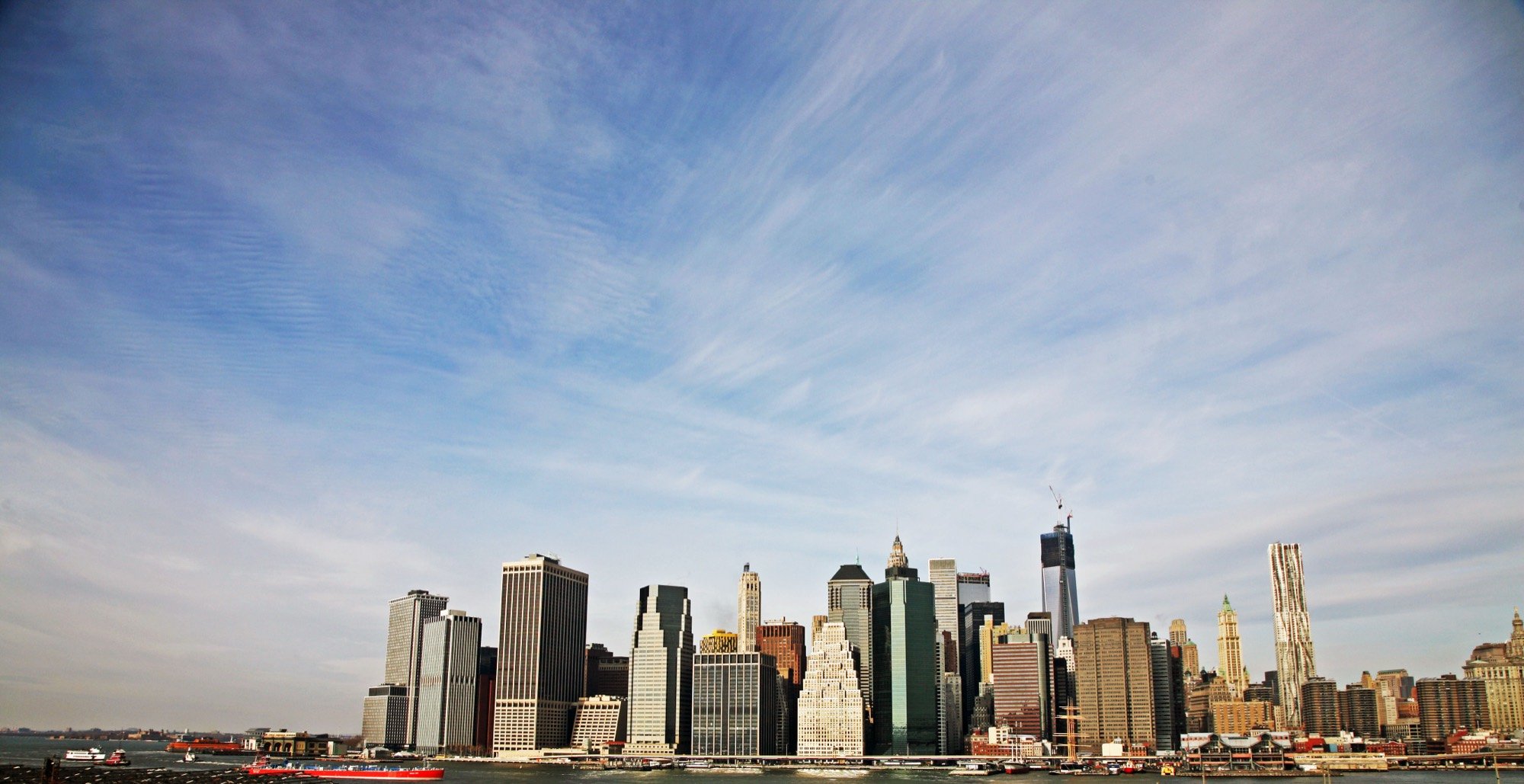 The Lower Manhattan skyline under streaked clouds