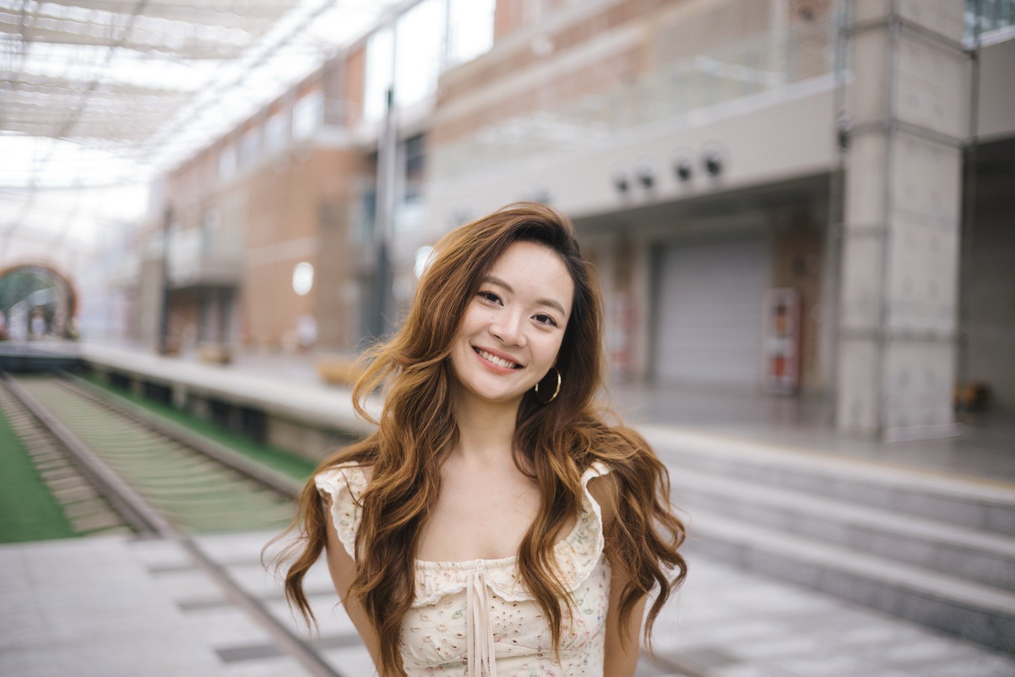 A smiling woman glancing back on a night-market street