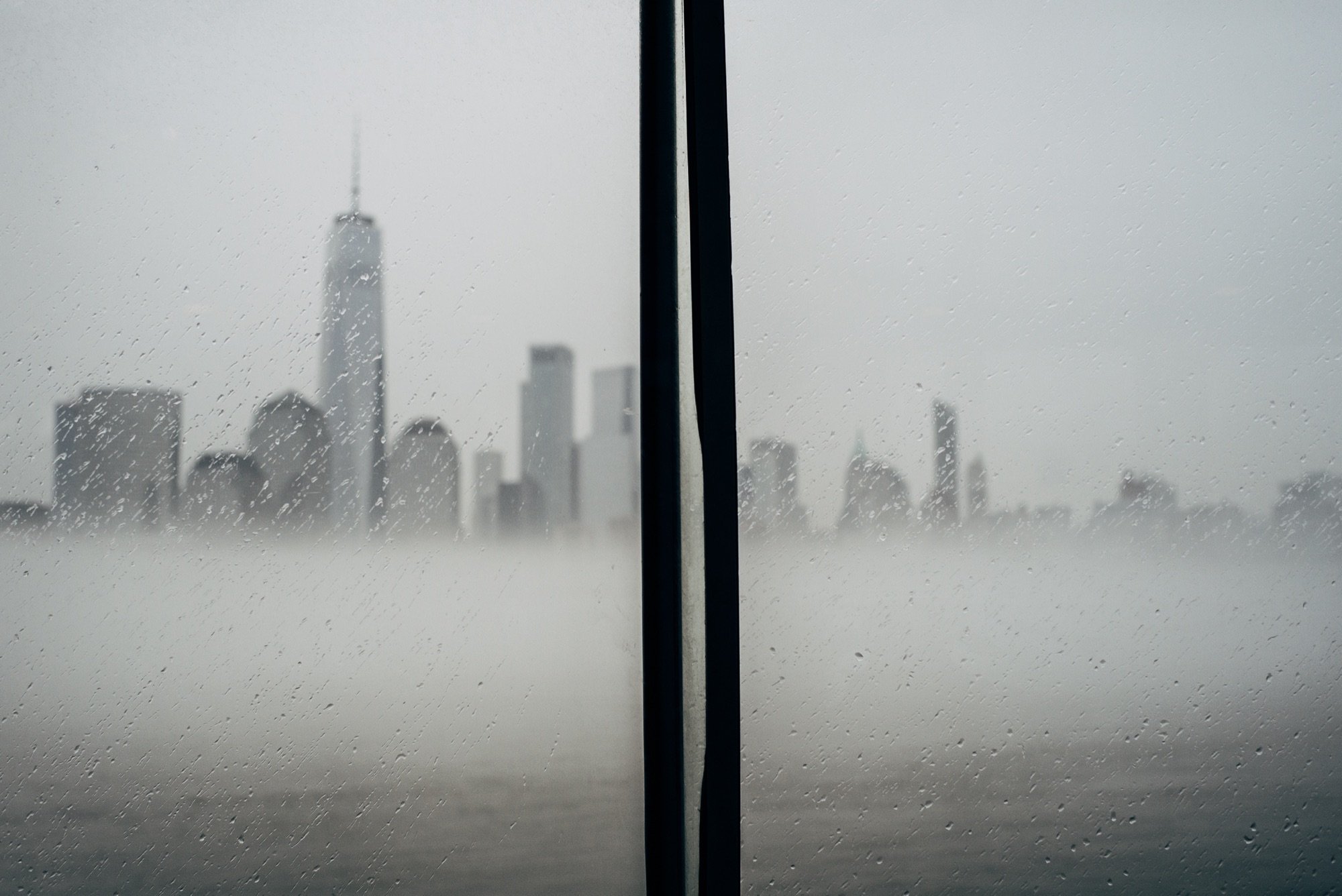 A foggy skyline through a wet window