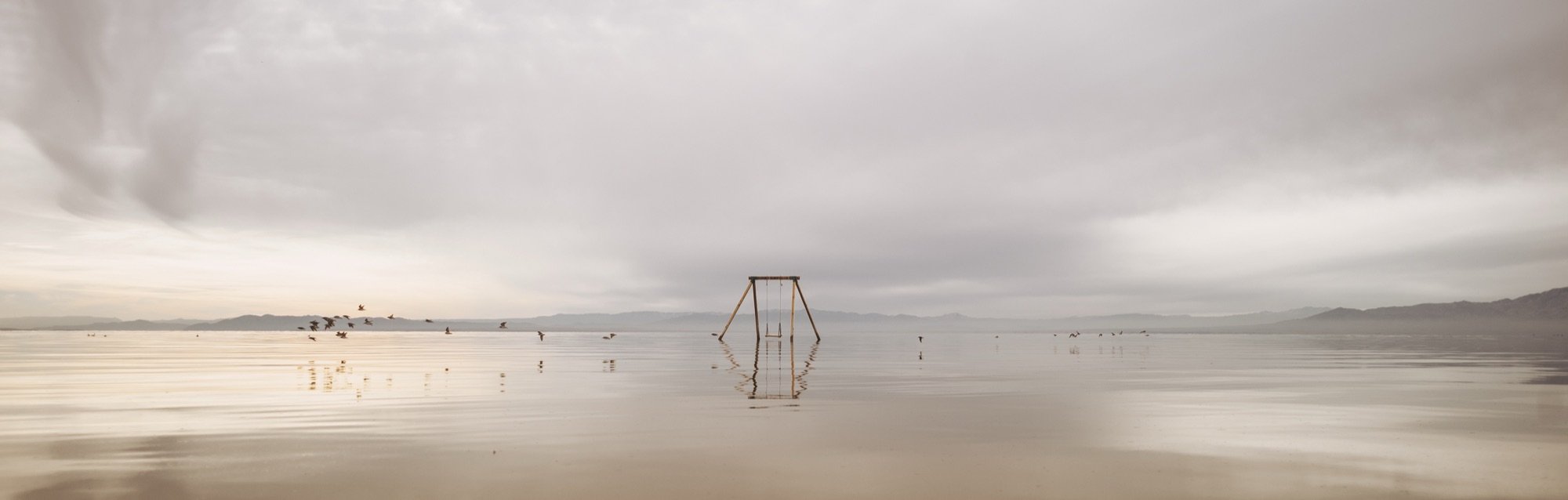 A lone swing in a flooded lake
