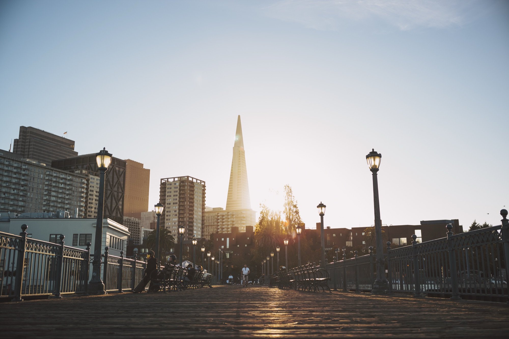 A boardwalk toward a skyline at sunset