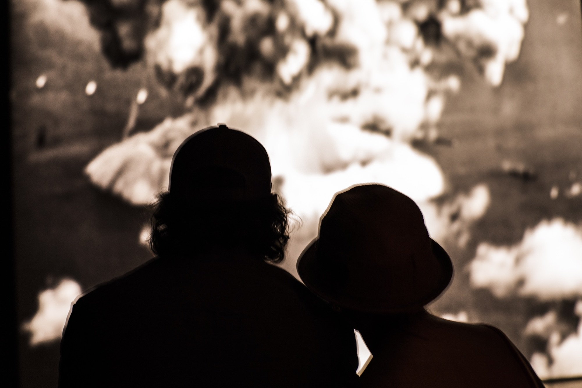 A couple silhouetted before a projection