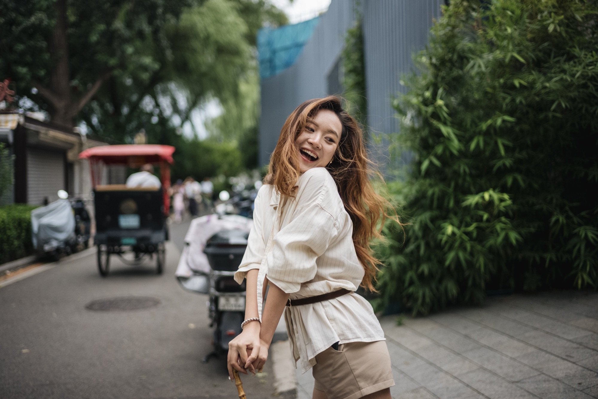 A smiling woman on a street